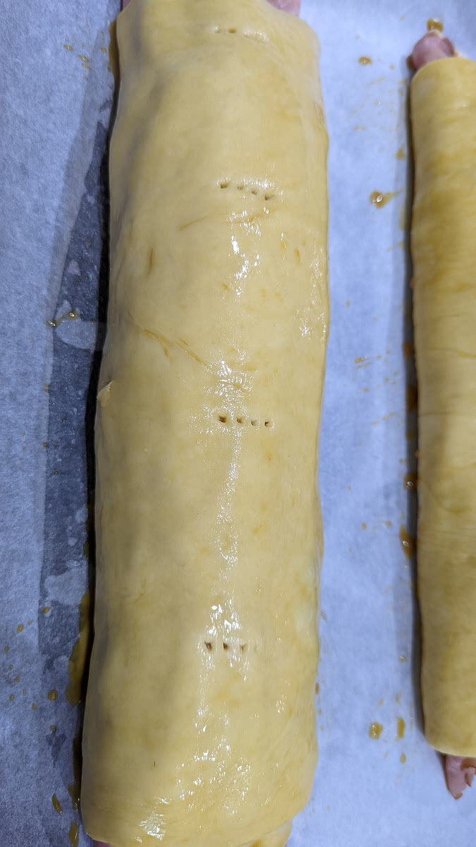 Stab the dough evenly on the top, brush with the egg mix and bake