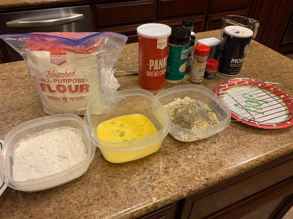 Place flour and eggs in two separate shallow bowls. In a third shallow bowl, combine panko, Parmesan, lemon zest, oregano, and cayenne. Season with salt and pepper.