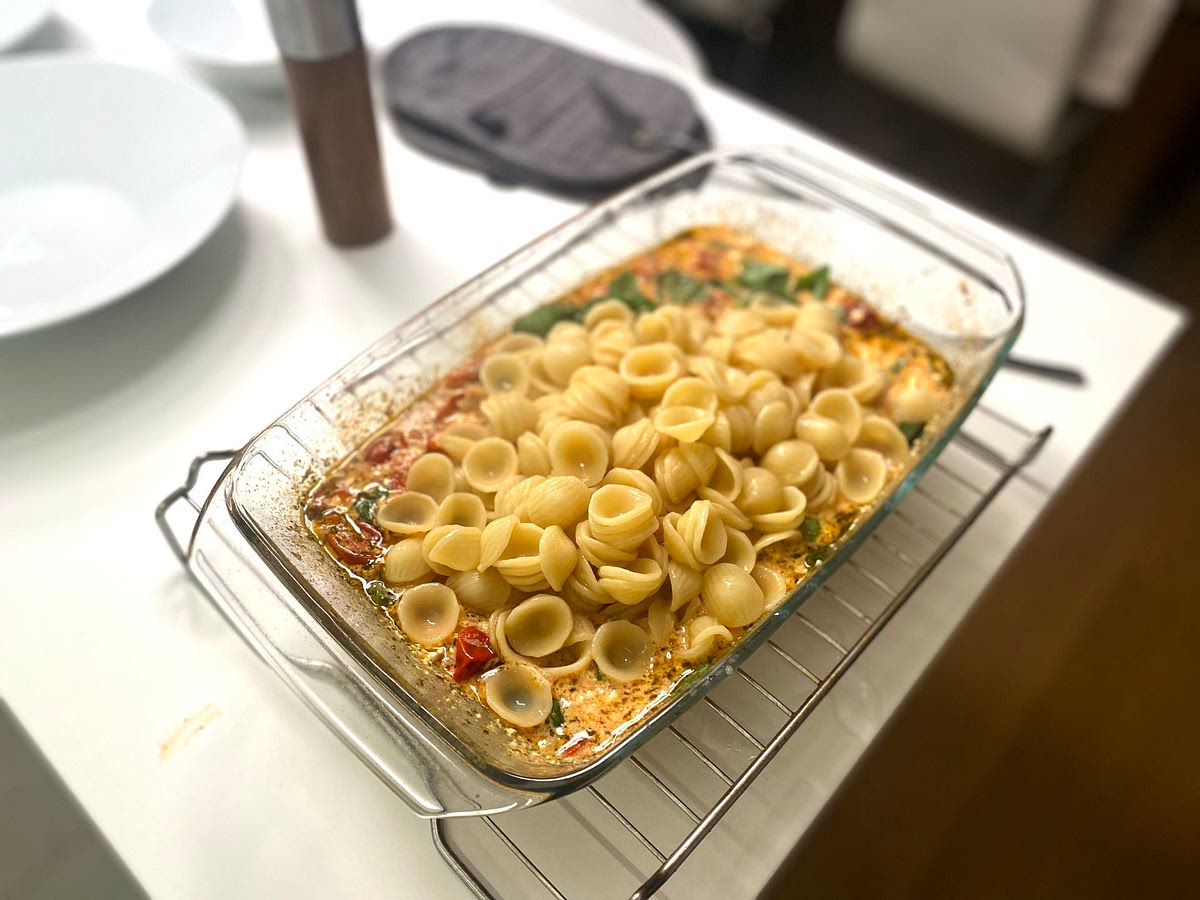Add the cooked pasta straight from the pot into the dish along with the basil leaves. I like to leave mine whole but you can also break them up with your fingers.