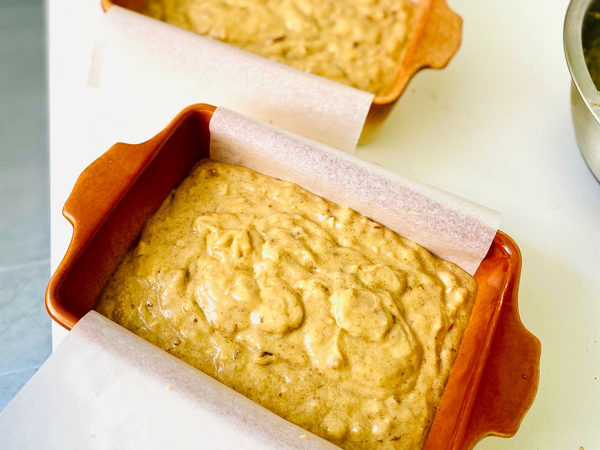 Reduce speed to low, add flour mixture, and mix until just combined. Add mashed bananas and mix just until combined. Fold in (don't mix) walnuts, if using. Scrape batter into prepared pan; smooth top.