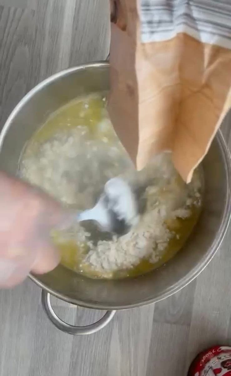 Take the water off the heat and add flour and stir constantly with a spatula.