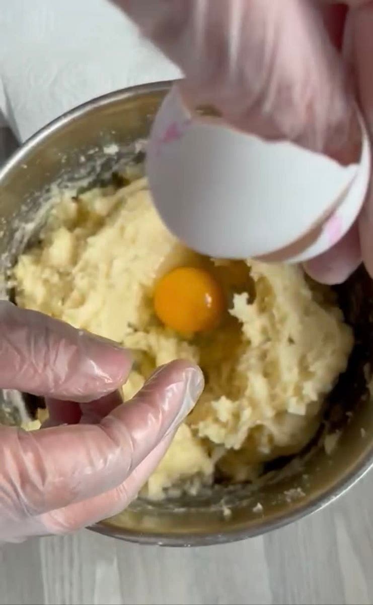 Let the dough cool down a little and add two eggs to the mixture. Blend until it is smooth. You can use your hands to knit the dough.
This will take time but keep your patience😏