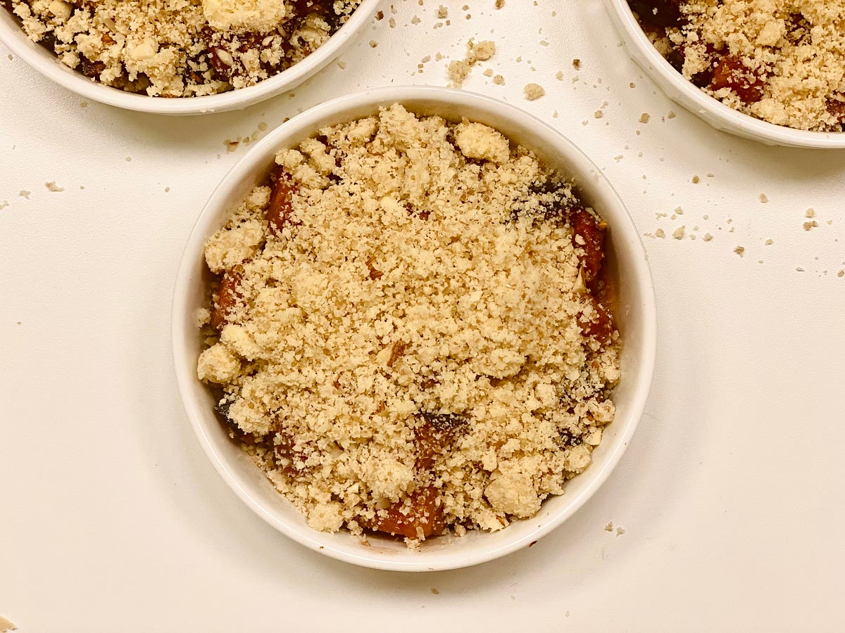 Spoon the fruit mixture into ovenproof small individual portions baking cups like ramekins, then sprinkle the crumble mixture on top.