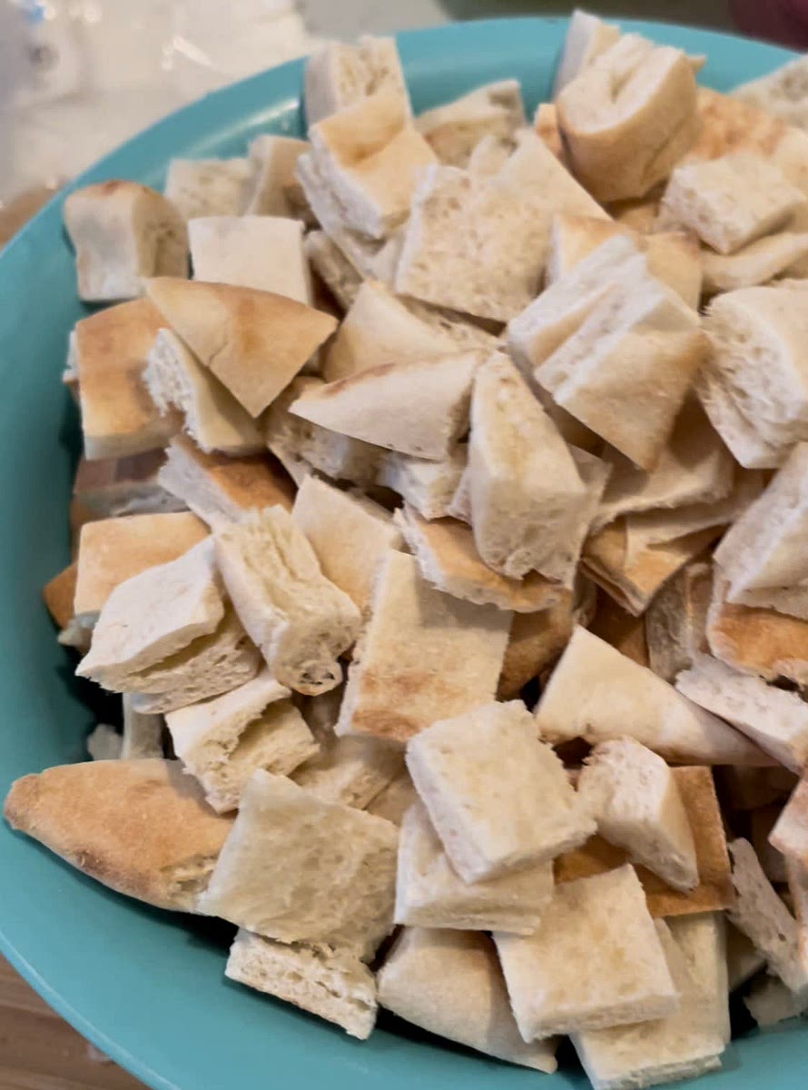 Cut 3 slices of pita bread into small squares