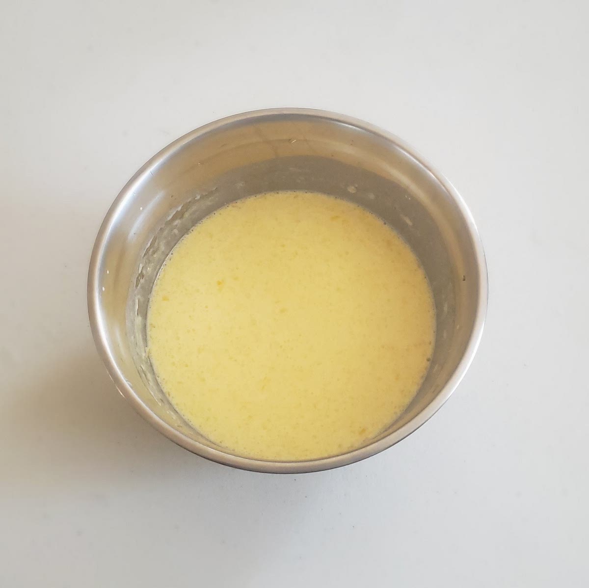 In a separate bowl, combine milk, buttermilk, melted butter, and egg yolks