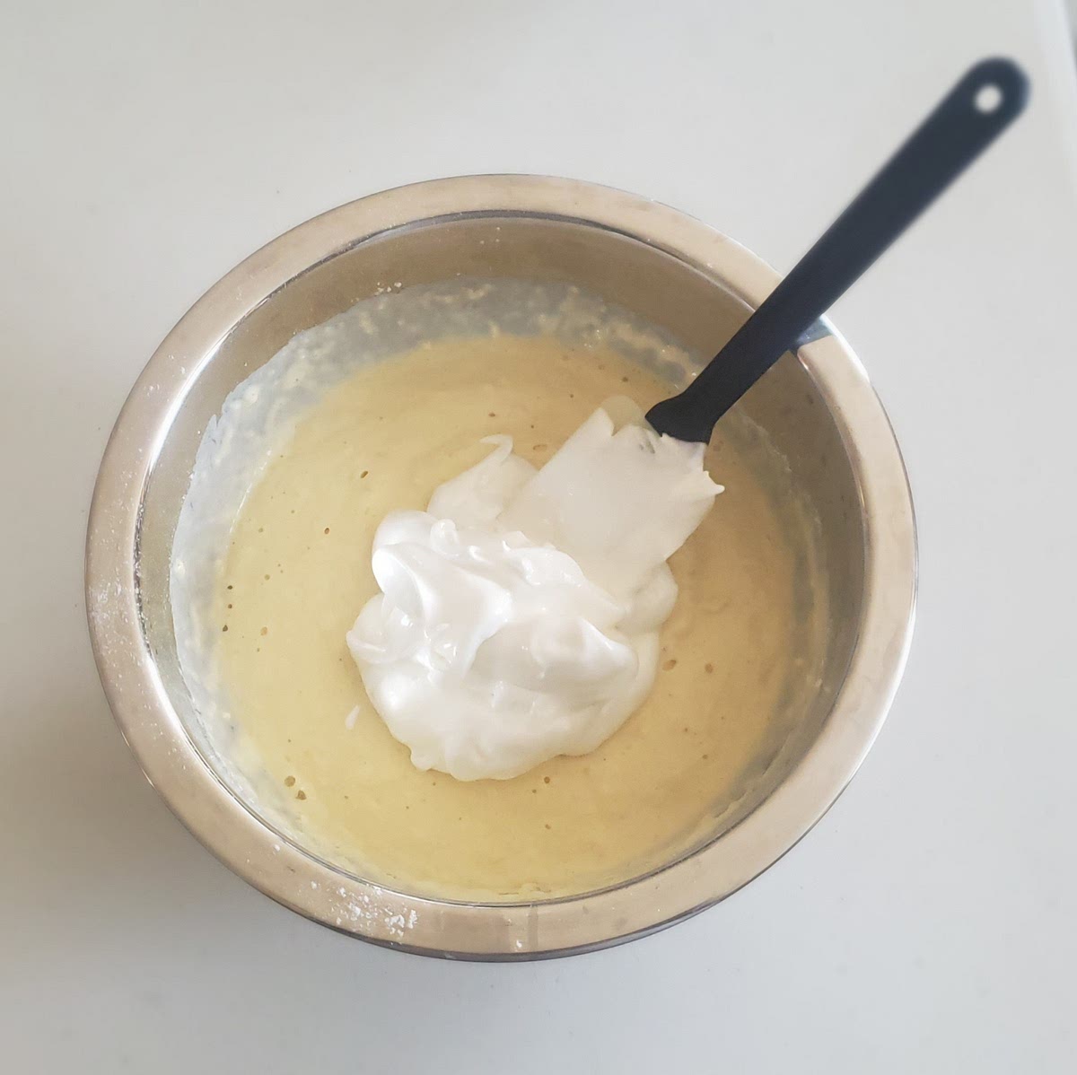 Slowly fold egg whites into the battery until it is fully incorporated