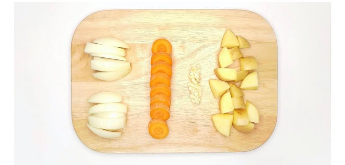 Peel and chop the brown onion[s] into wedges Top, tail, and slice the carrot[s] into large discs Crush the garlic cloves open by squashing them with the side of a knife and remove the skins Roughly chop the potato[es] into bite- sized pieces