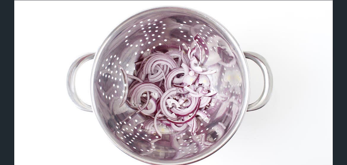 Preheat the oven to 200°C/ 180°C (fan)/ Gas 6 Boil a kettle Peel and finely slice the red onion s] Add the sliced onion to a colander and pour over a full kettle's worth of boiled water (this "blanches' the onion, which removes the acidity in the raw onion, making it less harsh to eat)