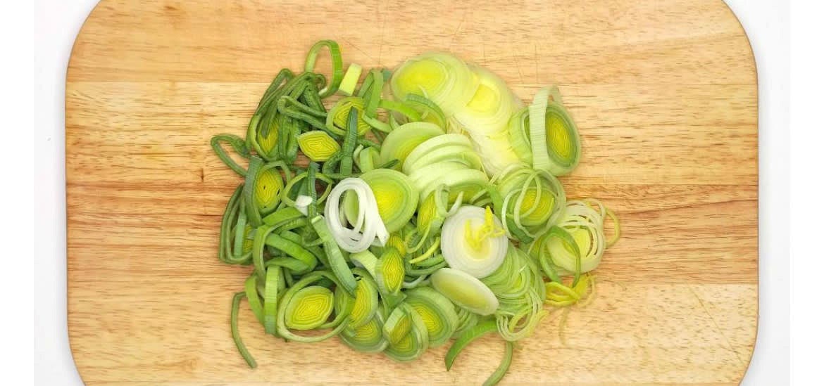 Boil a kettle Chop the leek[s] in half lengthways, then wash thoroughly to remove any grit from between the leaves Top, tail and slice finely