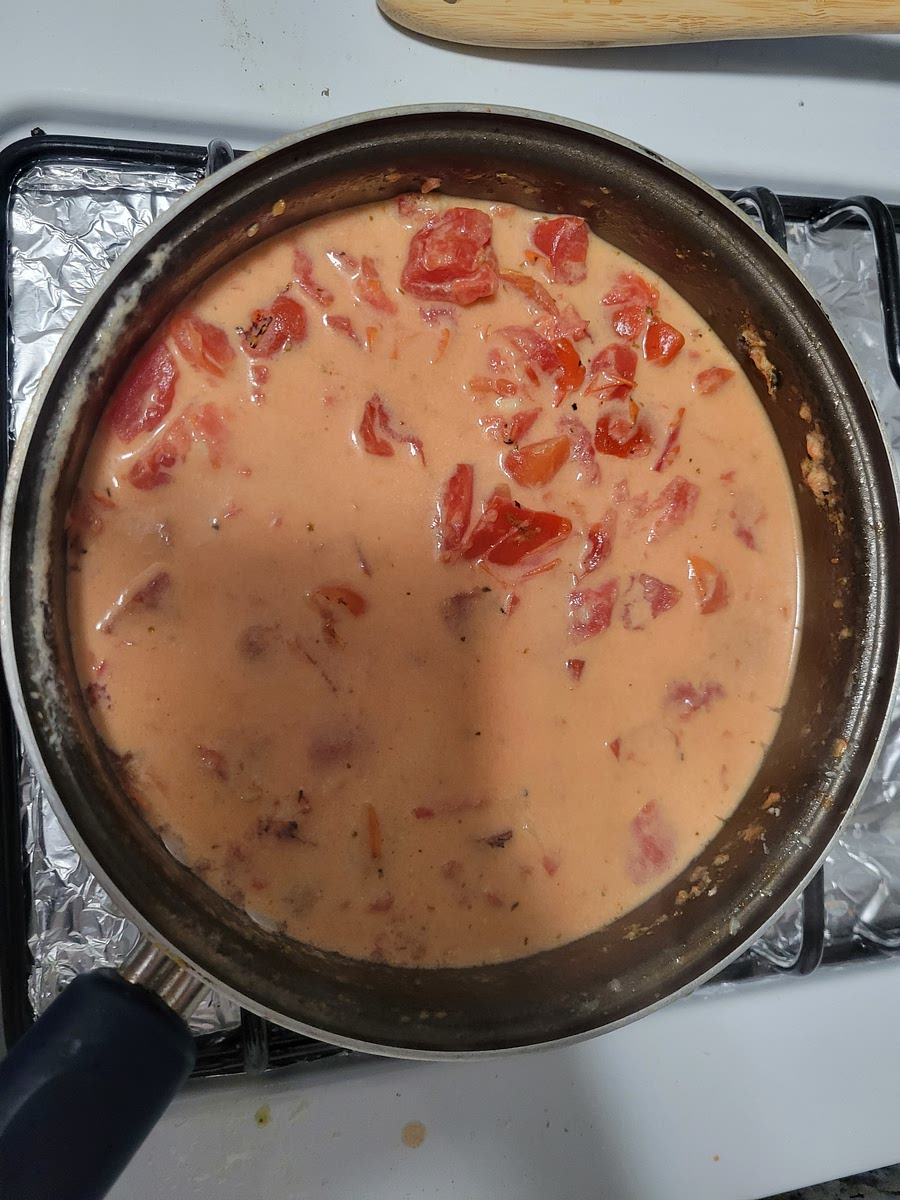 Prepare the sauce by heating olive oil in a large skillet on med heat. Add garlic and saute for 1 minute. Add white wine, oregano and tomatoes. Stir and simmer for about 5 minutes. Add parmesan cheese and cream, simmer a for few minutes longer while you fry the shrimp. Just before serving, whisk in the juice of 1/2 a lemon. Season with salt and pepper, to taste.