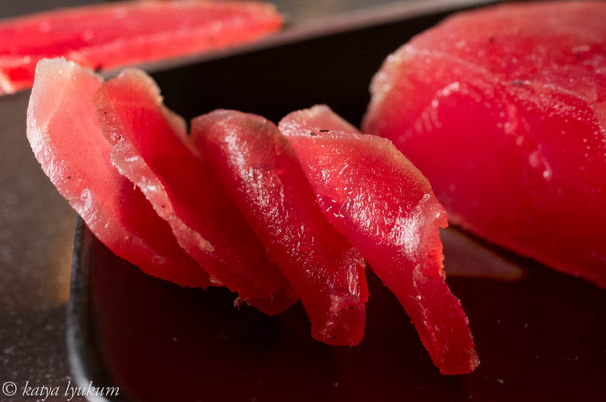 Slice cured tuna for serving.