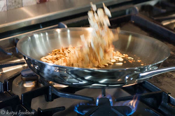 Toast almond slices. Reserve a few for the topping.