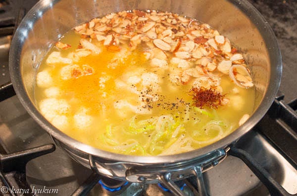 Combine cooked leeks, fried cauliflower, toasted almonds, chicken stock, spices, and seasonings in a pot. Bring to boiling on high heat, reduce to low, and simmer for 5 minutes.