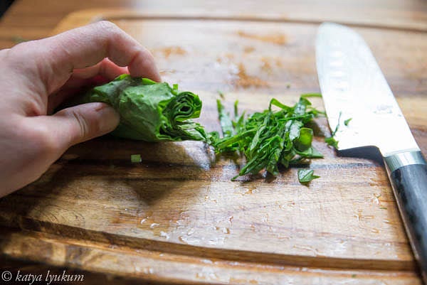 Roll sorrel leaves and cut them using the chiffonade technique.