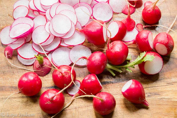 Wash and thinly slice radishes.