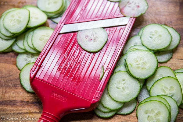 Wash and thinly slice cucumbers.