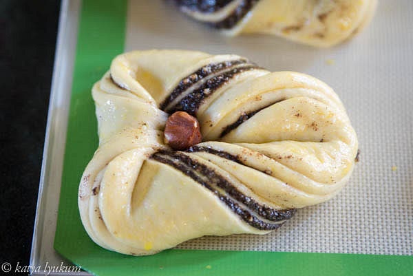 Arrange shaped buns in a lined with silicone mat baking sheet. For 10 buns, use one full-size or two half-size baking sheets. Brush with egg wash and sprinkle with poppy seeds.
