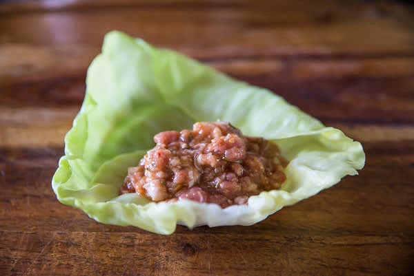 Stuff and roll cabbage leaves. Use about 3 tbsp of stuffing per leaf.