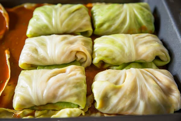 Place cabbage rolls side by side into a baking dish.