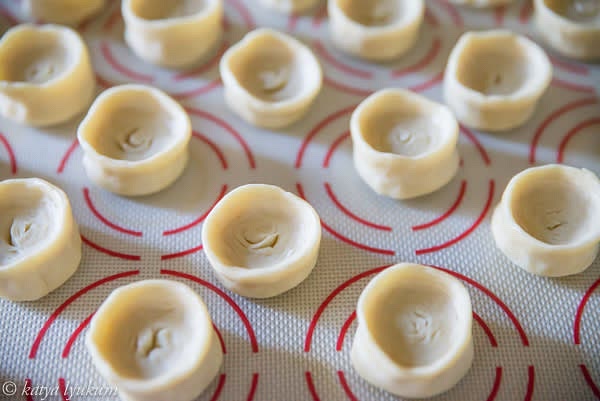 To ensure that layers of dough look attractive when baked, do not press the bottom. Instead, gently stretch the sides of each portion up to form a pocket for the filling.