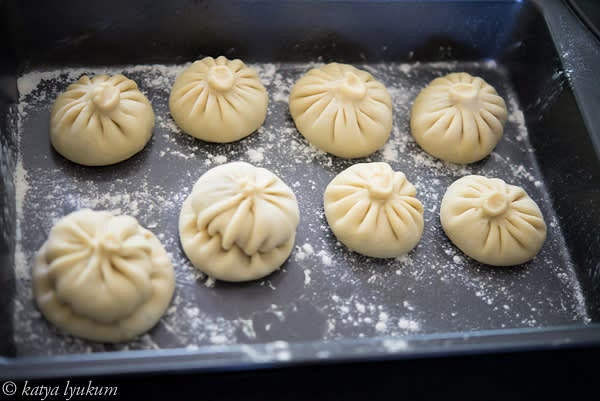 Work with one dumpling wrapper at a time, keeping the rest covered with plastic wrap. Roll each wrapper 2.5" D, fill it with 1.5 tbsp of meat mixture, shape, and place under the plastic wrap. Repeat with all wrappers.