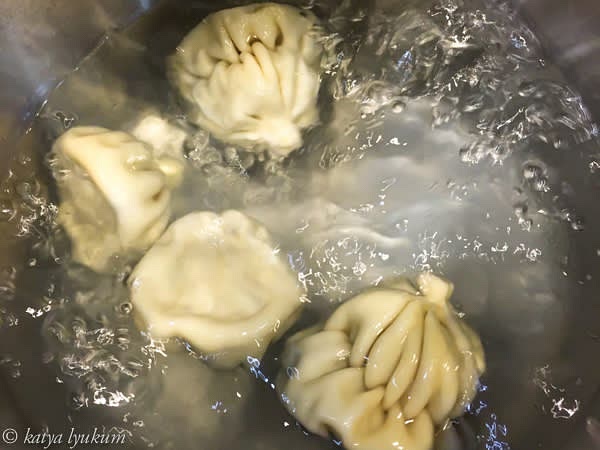 The water will be boiling by the time you are done shaping the dumplings. Place all dumplings in boiling water at the same time and cook for about 5 minutes. Do not cover. In the beginning, they will sink to the bottom. When they are cooked, they will float. Give them about 2 more minutes after that happens and strain.