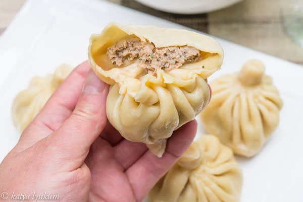 Place 1-2 tbsp butter and hot cooked dumplings in a bowl. Gently shake the bowl to move dumplings. Their heat will melt the butter, and butter will coat them, preventing sticking and drying. Serve plain or sprinkled with freshly ground black pepper. (Picture shows double khinkali.)