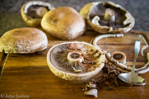 Prep mushrooms. Gently twist off or cut off the stem of each mushroom. Hold mushroom cap in one hand, use a spoon to scrape out the gills, and discard.