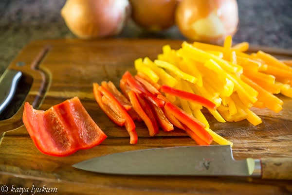 Remove stems, seeds, and veins of sweet salad peppers and julienne them.