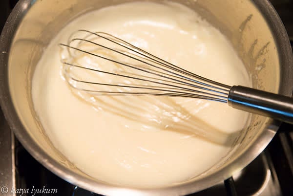 Place a saucepan over medium heat and melt butter. Add flour, mix, and cook, stirring for a few minutes until it smells like cookies. Take the sauce pan off the heat and whisk in 1 cup of milk. Return to the heat cook until milk is thickened.