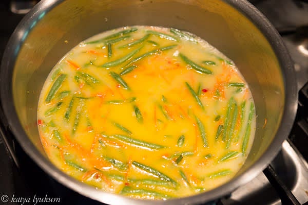 Add stock and bring to simmer. Adjust seasoning, add green beans and corn, bring to simmer again, and cook for 2 minutes.