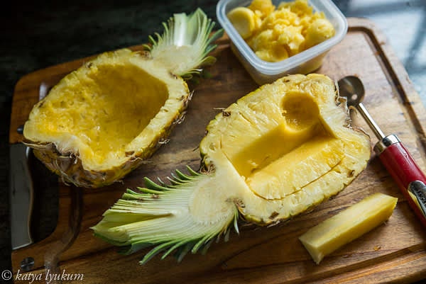 Cut off the core. Score around the inside of the pineapple for the future 1/2" thick "rim." Use a melon knife to scoop out the flesh. Reserve it. Gently scrape the bottom of the pineapple boat with a spoon to make it smooth.