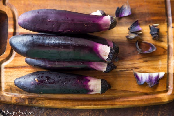 Preheat grill on high. Wash and prepare eggplants for grilling: make 5-6 scores and a hole in the center for steam to escape during the grilling.