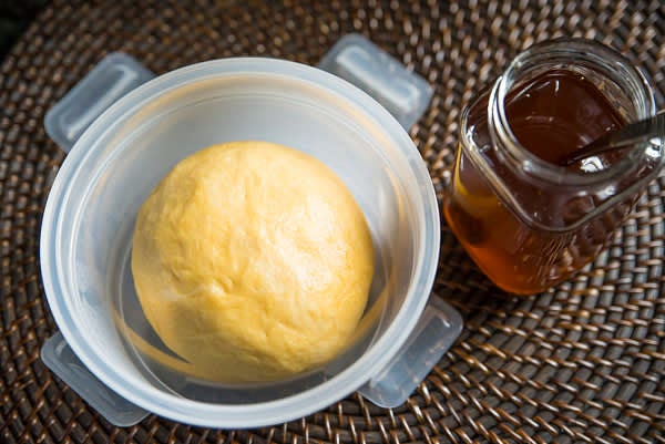 In a bowl, mix all dry ingredients. Dissolve salt in water and add it to the bowl in a cup. Stir to make large lumps. Add oil. Knead the dough till soft and smooth. It won't be sticky. Sniff your hands — they smell delicious! Divide the dough into two equal parts and place in closed containers.