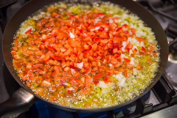 Preheat 1 cup of Spanish olive oil to 375F/190C in a saucepan. Add all diced vegetables at once. Bring the oil temperature back to 375F and keep it the same.
