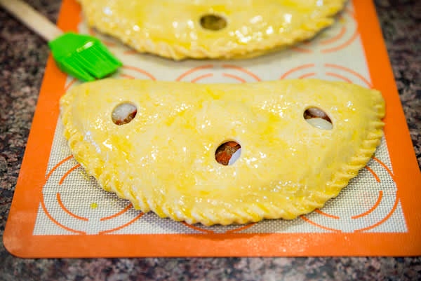 Shape pies and secure the filling. Apply egg wash.