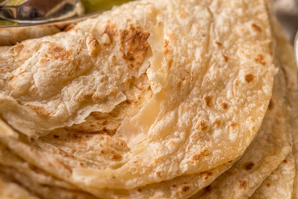 Cook flatbreads on a hot skillet, flipping, a few seconds on each side. Pile cooked flatbreads and fluff them while they are still hot.