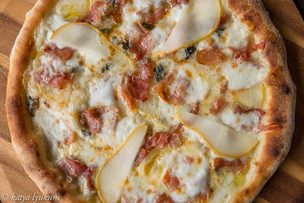 Bake on stone for 6-8 minutes. Season with freshly ground black pepper and serve.