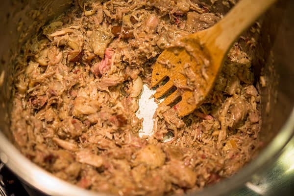 For tamales: mix with some sauce (1 cup of Basic Ancho Adobo for 2 pounds of cooked carnitas) and shred with a fork.