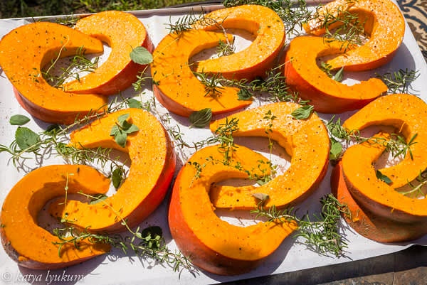 Preheat oven to 350F. Wash Cinderella pumpkin. Slice it in half, remove seeds, and slice 2" thick. Line the baking sheets with parchment paper. Arrange slices and favorite herbs (thyme, rosemary, sage, etc.), spray them with olive oil, season with black pepper, coarse salt, and brown sugar. Bake for 1 hour. Scrape soft pumpkin flesh and store it in closed containers, refrigerate for 3-4 days, or freeze for later use. Discard pumpkin skin and herbs.