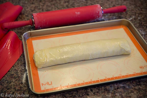 Gently roll the strudel onto a smaller silicon mat and transfer it into a baking pan. Make sure the final position of the strudel is seam-side down. Brush it with melted butter. Bake on the middle rack for 25-30 minutes or until golden.