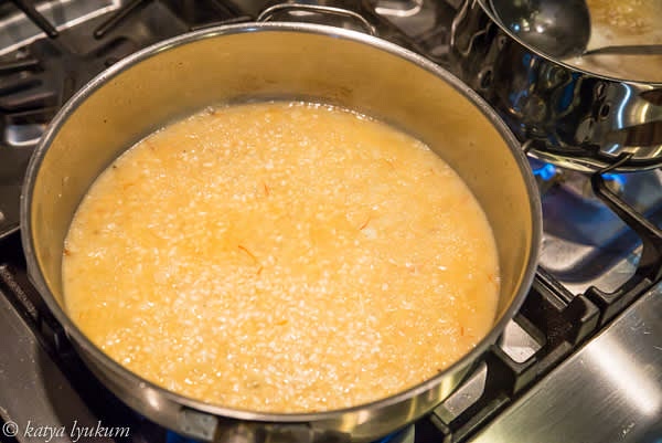 Add the first portion (~2-3 cups) of simmering stock to cover the rice. Sprinkle with saffron. Set the timer for 20 minutes.