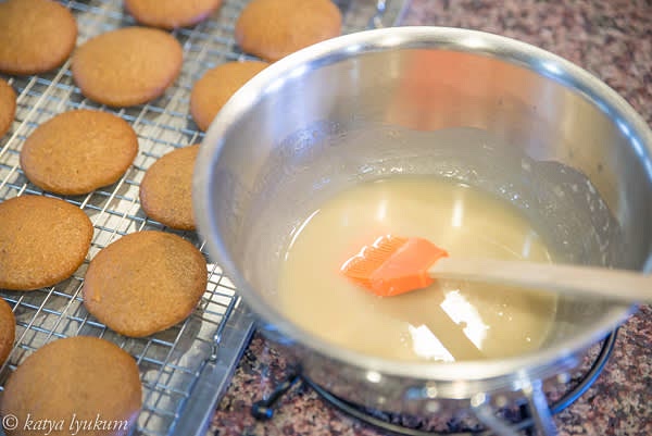 Meanwhile, make the glaze. In a saute pan, combine white sugar and water and bring to boiling. Do not let it boil for longer than a few seconds! Take it off the heat, add rum and almond extract, stir and let cool to room temperature. Add confectioners powdered sugar, mix, and keep at room temperature until ready to use.