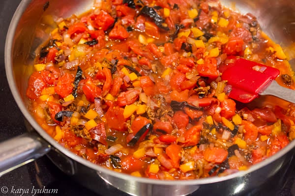 Heat olive oil in a sauté pan over medium-high and sauté onions until tender. Add peppers and tomatoes, reduce the heat, cover with a lid, and cook for 7-10 minutes.