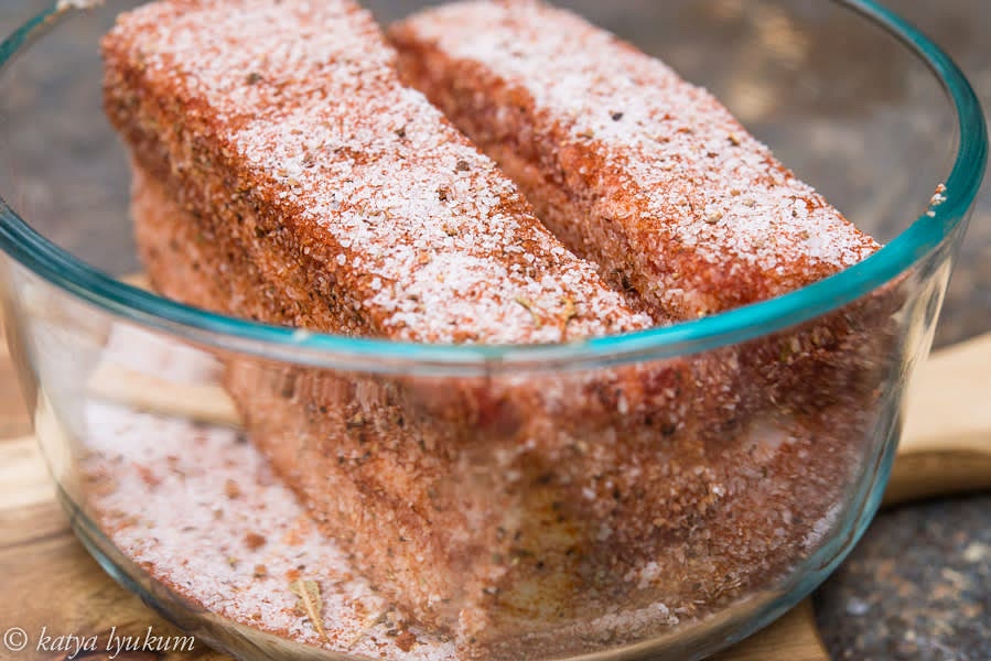 Spread salt rubs on parchment paper and roll blocks of pork belly in it, pressing lightly on each side. Place them pigskin down into containers.