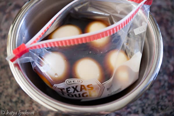 Meanwhile, make the broth. Dissolve sugar in warm water. Add sake, soy sauce, and mirin and stir. For 5-6 eggs, use a 1-pint zip lock bag. Place it in a small bowl and fill it with the broth. Peel the eggs and submerge them into the broth.