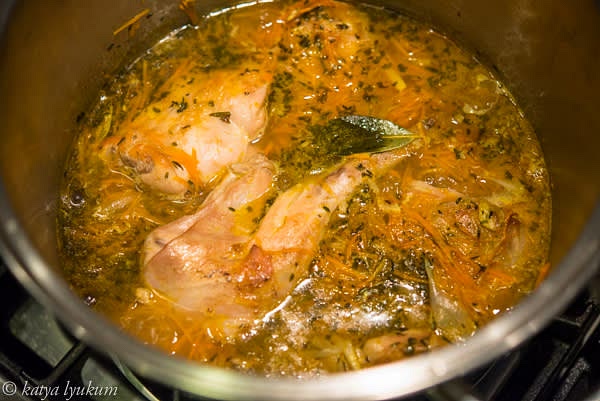 Peel and slice onion. Peel and grate carrots. In a large skillet, melt 1 tbsp clarified butter over medium heat and saute onions and carrots until soft and fragrant. Transfer them into a pot with a rabbit. Add wine, stock, spices, and dry herbs. Bring to boiling over high heat, reduce the heat to a minimum and slowly simmer uncovered for 1.5 hours.