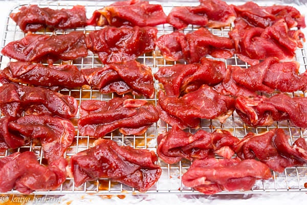 Pour marinade into a bowl and place all slices of meat into it. Carefully separate slices one by one and make sure they are coated with marinade on both sides. Arrange them on the rack as shown in the picture. Spray them with oil. Preheat the broil.