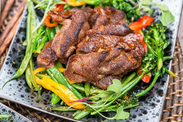 Over high heat, finish the stir fry by folding 2 tbsp of the marinade into the vegetables. Turn off the heat and serve vegetables with bulgogi on top.