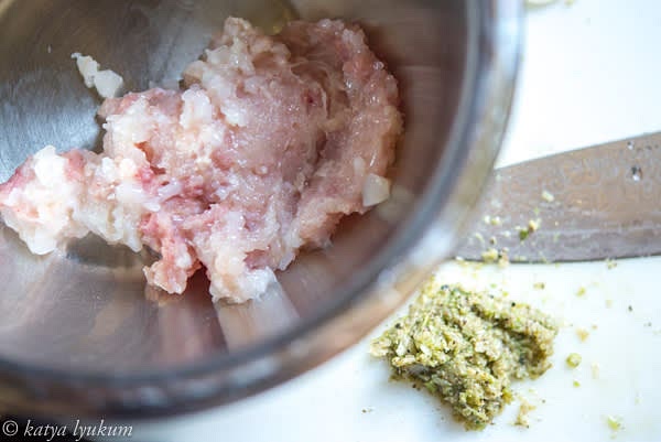 Mince chicken (and prawns or scallops, if using). Combine 1 tsp of garlic, 1 tsp of cilantro stems, and 1/3 tsp ground pepper and make a paste using a knife or mortar and pestle. Measure fish sauce and palm sugar.